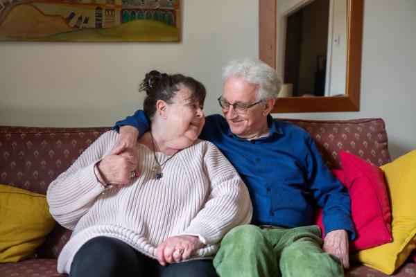 Ältere Frau und jüngere sitzen auf dem Sofa